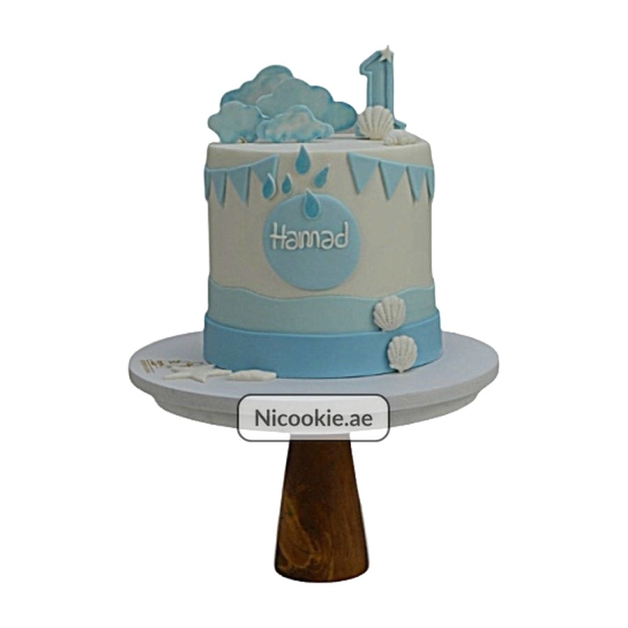 Ocean theme boy cake with clouds, raindrops, shells, and a number 1 topper.