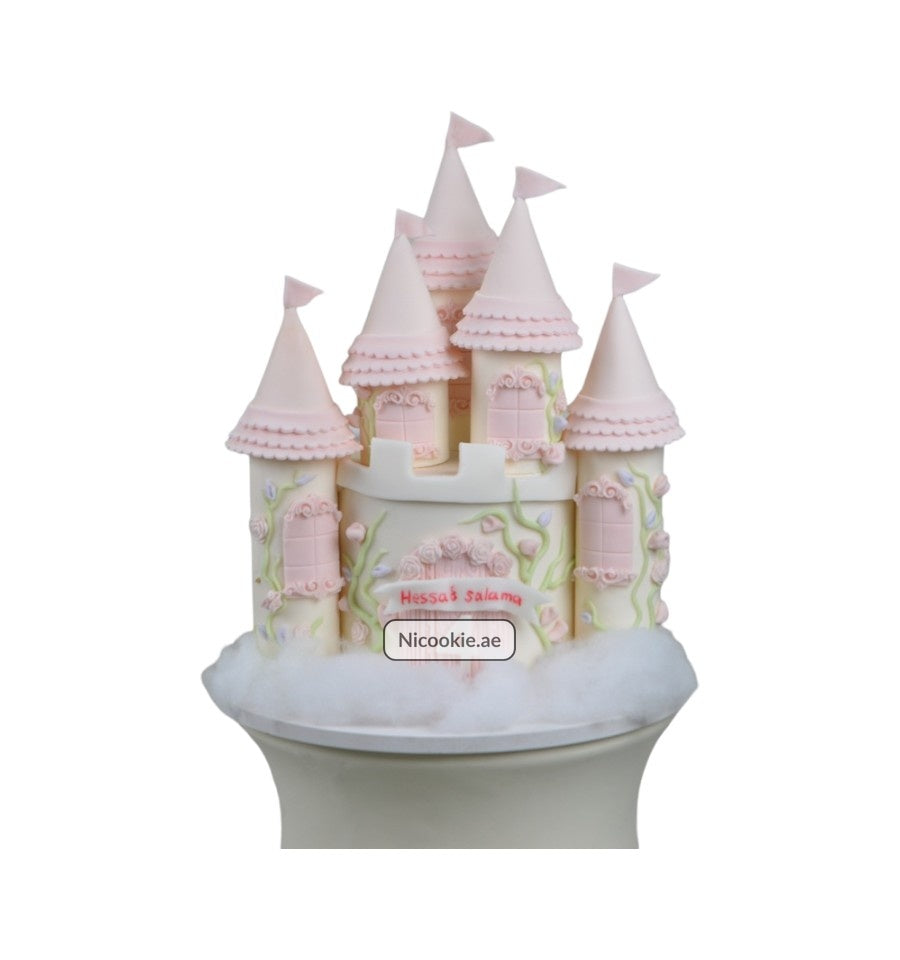 Pastel princess castle cake with pink towers and floral accents.