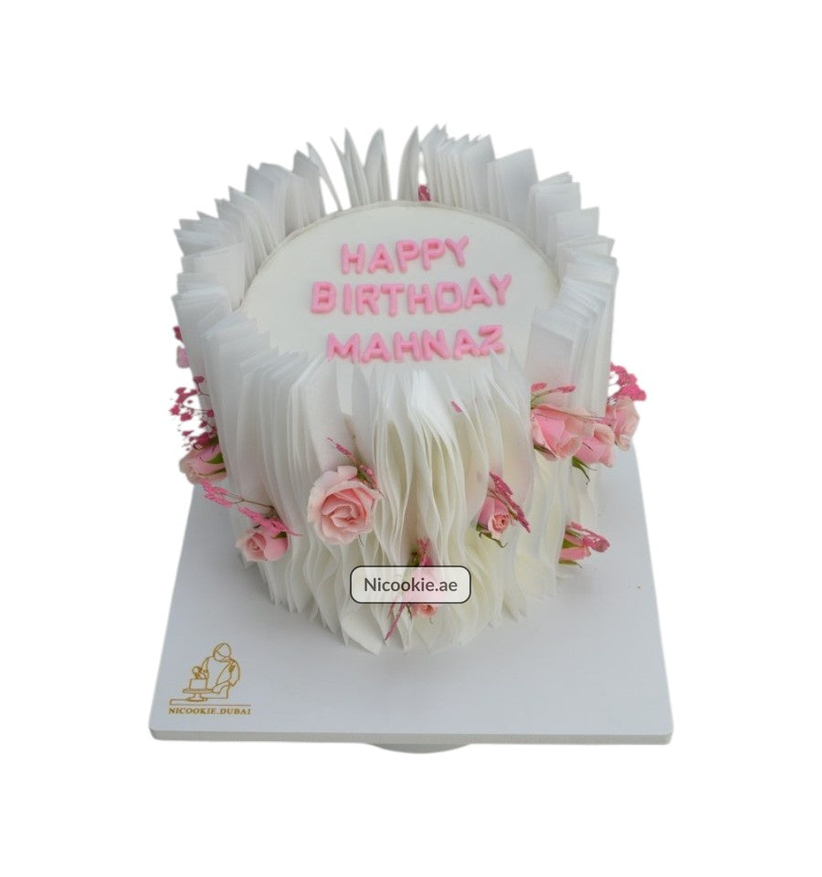 Petal Cascade Cake with white ruffles and pink roses.