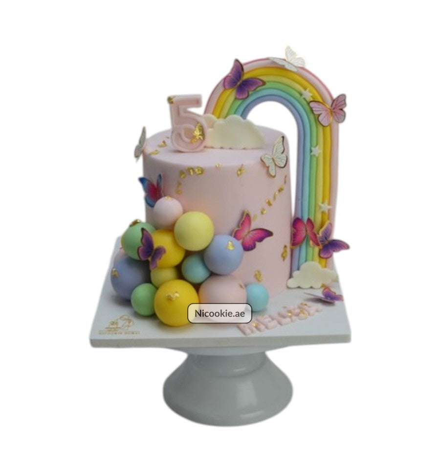 Pastel rainbow and butterfly cake with a number 5 topper.