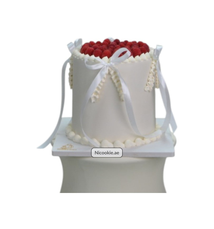 Raspberry Ribbon Delight cake with white frosting and fresh raspberries.