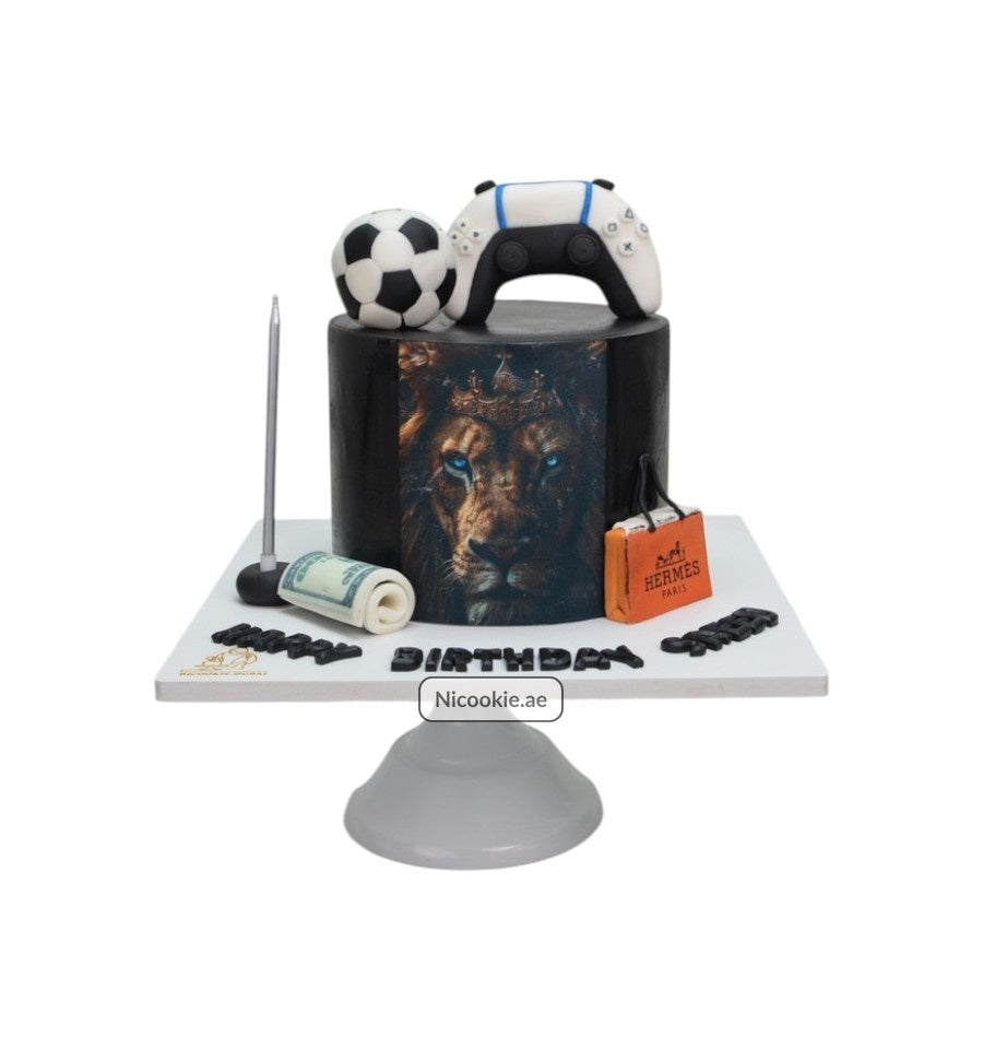 Black cake with lion, game controller, soccer ball, money, and Hermes bag.