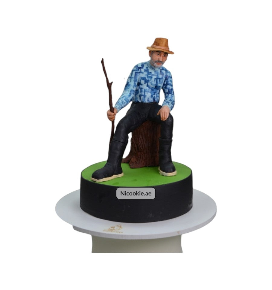 Rustic cake with a figure of a man sitting on a tree stump.