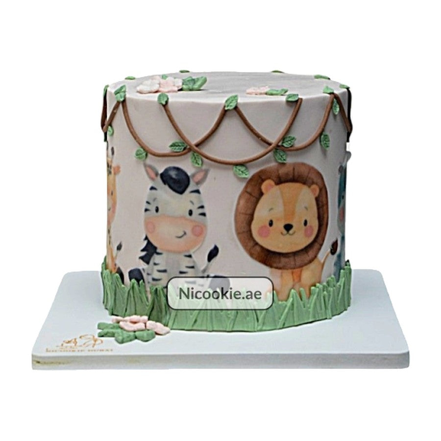 A round cake decorated with cartoon safari animals and vines.
