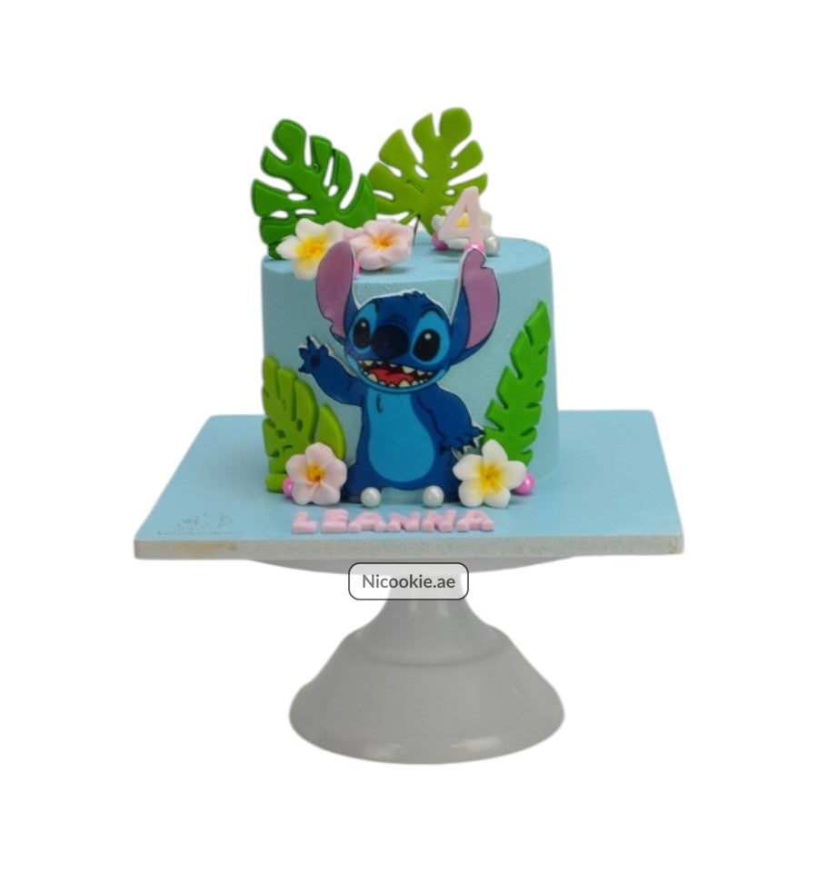 A blue cake with Stitch, tropical leaves, and flowers.