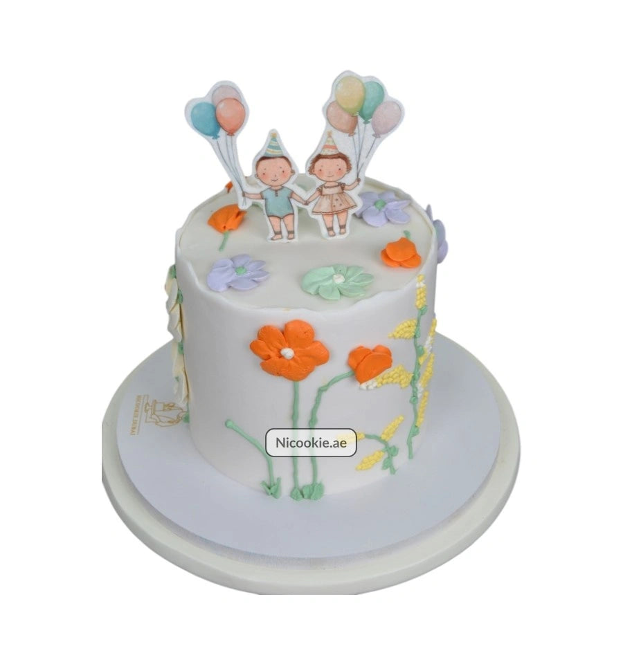 Whimsical garden party cake with children and balloons.